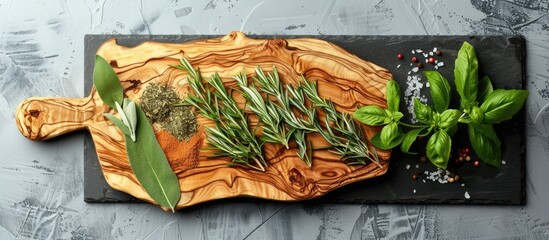 Sticker - A rustic olive wood cutting board with spices and herbs for cooking placed on slate set against a clean white background with ample copy space image