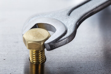 Wall Mural - Wrench tightens bolt in steel billet. Spanner, bolt, screw and nuts.