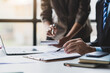 © Wasan - Coworkers are discussing company growth charts and graphs during a budget meeting. Business adviser meeting to discuss the situation on the financial report. Accounting, investment and marketing plan.