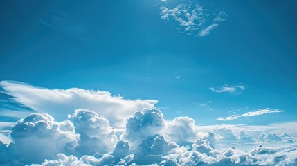 Canvas Print - A clear blue sky background is highlighted by fluffy white clouds in a blue sky background. White fluffy clouds are suspended in a blue sky behind clear blue sky.