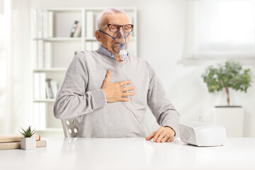 Wall Mural - Elderly man with breathing problem using a nebulizer