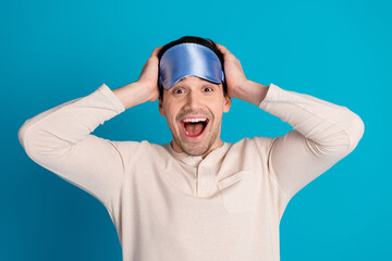 Poster - Portrait of nice young man hands touch head wear pajama isolated on blue color background