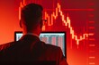 © artitwpd - A professional looking at a computer screen with a red and black stock market graph in the background.