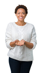 Sticker - Beautiful young african american woman wearing sweater over isolated background Smiling with hands palms together receiving or giving gesture. Hold and protection