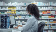 © ЮРИЙ ПОЗДНИКОВ - A woman is seated at a desk inside a pharmacy, diligently working on a computer