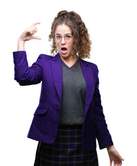 Wall Mural - Young brunette student girl wearing school uniform and glasses over isolated background smiling and confident gesturing with hand doing size sign with fingers