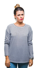 Wall Mural - Young beautiful woman casual stripes sweater over isolated background skeptic and nervous, frowning upset because of problem. Negative person.