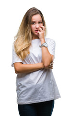 Poster - Young beautiful blonde woman wearing casual white t-shirt over isolated background looking stressed and nervous with hands on mouth biting nails. Anxiety problem.