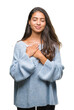 © Krakenimages.com - Young beautiful arab woman wearing winter sweater over isolated background smiling with hands on chest with closed eyes and grateful gesture on face. Health concept.