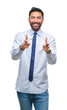 © Krakenimages.com - Adult hispanic business man over isolated background pointing fingers to camera with happy and funny face. Good energy and vibes.