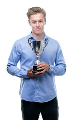 Sticker - Young handsome blond man holding a trophy with a confident expression on smart face thinking serious