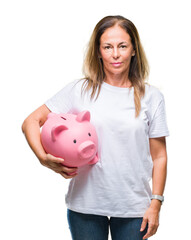 Wall Mural - middle age hispanic woman saving money using piggy bank over isolated background with a confident ex