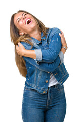 Poster - Beautiful middle age woman wearing casual denim jacket over isolated background Hugging oneself happy and positive, smiling confident. Self love and self care