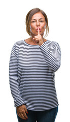 Poster - Middle age senior hispanic woman over isolated background asking to be quiet with finger on lips. Silence and secret concept.