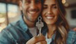 © imagineRbc - A happy couple is holding keys, smiling and looking at the camera