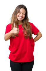 Canvas Print - Young beautiful brunette woman wearing red t-shirt over isolated background doing happy thumbs up gesture with hand. Approving expression looking at the camera showing success.