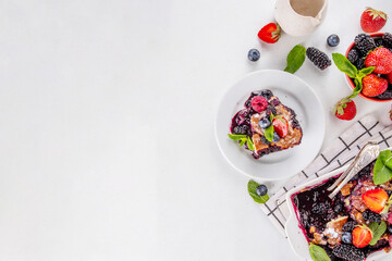 Wall Mural - Homemade sweet berry cobbler pie cake with various garden forest berries - strawberry, blackberry, blueberry, healthy summer dessert recipe in baking pan and plate, copy space