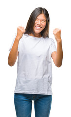 Canvas Print - Young asian woman over isolated background very happy and excited doing winner gesture with arms raised, smiling and screaming for success. Celebration concept.