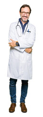 Canvas Print - Handsome middle age doctor man wearing medical coat with a happy and cool smile on face. Lucky person.