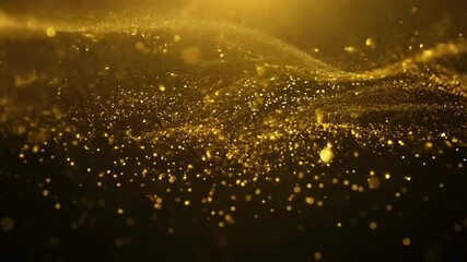 Leinwandbilder - Golden particles float and shimmer on a black background.
