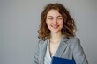 © LimeSky - Image of a cheerful businesswoman holding blue folder on white background