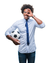 Poster - Afro american manager man holding soccer ball over isolated background with happy face smiling doing ok sign with hand on eye looking through fingers