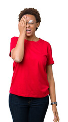 Wall Mural - Beautiful young african american woman wearing glasses over isolated background Yawning tired covering half face, eye and mouth with hand. Face hurts in pain.