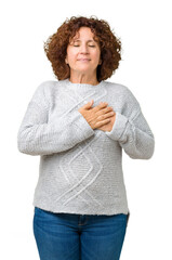 Sticker - Beautiful middle ager senior woman wearing winter sweater over isolated background smiling with hands on chest with closed eyes and grateful gesture on face. Health concept.