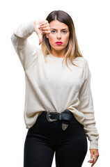 Canvas Print - Young beautiful woman casual white sweater over isolated background looking unhappy and angry showing rejection and negative with thumbs down gesture. Bad expression.