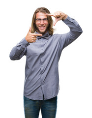 Poster - Young handsome man with long hair wearing bow tie over isolated background smiling making frame with hands and fingers with happy face. Creativity and photography concept.