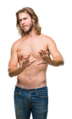 Poster - Young handsome shirtless man with long hair showing sexy body over isolated background disgusted expression, displeased and fearful doing disgust face because aversion reaction. With hands raised.