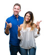 © Krakenimages.com - Young couple in love over isolated background success sign doing positive gesture with hand, thumbs up smiling and happy. Looking at the camera with cheerful expression, winner gesture.