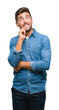 © Krakenimages.com - Young handsome man over isolated background with hand on chin thinking about question, pensive expression. Smiling with thoughtful face. Doubt concept.