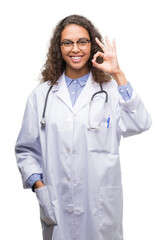 Canvas Print - Young hispanic doctor woman doing ok sign with fingers, excellent symbol