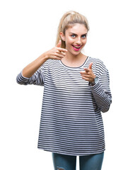 Poster - Young beautiful blonde woman wearing stripes sweater over isolated background pointing fingers to camera with happy and funny face. Good energy and vibes.