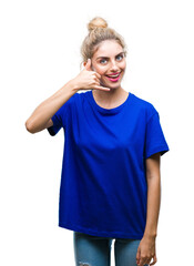 Poster - Young beautiful blonde and blue eyes woman wearing blue t-shirt over isolated background smiling doing phone gesture with hand and fingers like talking on the telephone. Communicating concepts.