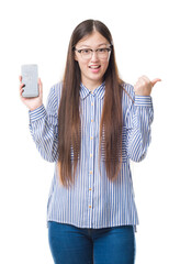 Sticker - Young Chinese woman over isolated background showing broken smartphone screen pointing and showing with thumb up to the side with happy face smiling