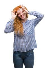 Poster - Young redhead bussines woman doing ok gesture with hand smiling, eye looking through fingers with happy face.