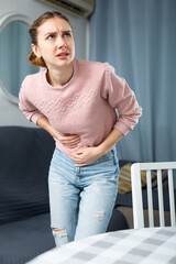 Wall Mural - Young woman suffering from abdominal pain, feeling stomachache