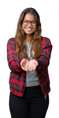 Canvas Print - Young beautiful brunette woman wearing jacket and glasses over isolated background Smiling with hands palms together receiving or giving gesture. Hold and protection