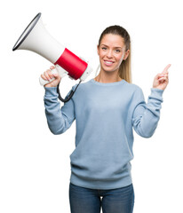 Sticker - Beautiful young woman holding megaphone very happy pointing with hand and finger to the side