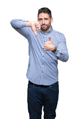 Canvas Print - Young handsome man over isolated background Doing thumbs up and down, disagreement and agreement expression. Crazy conflict