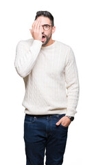 Canvas Print - Young handsome man wearing glasses over isolated background covering one eye with hand with confident smile on face and surprise emotion.