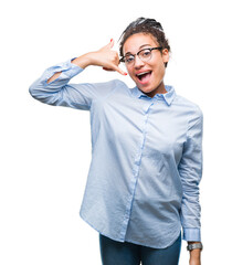 Poster - Young braided hair african american business girl wearing glasses over isolated background smiling doing phone gesture with hand and fingers like talking on the telephone. Communicating concepts.