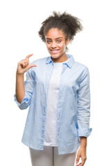 Poster - Young afro american woman over isolated background smiling and confident gesturing with hand doing size sign with fingers while looking and the camera. Measure concept.