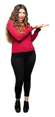 Sticker - Young beautiful woman wearing red sweater Pointing to the side with hand and open palm, presenting ad smiling happy and confident