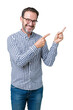 © Krakenimages.com - Handsome middle age elegant senior business man wearing glasses over isolated background smiling and looking at the camera pointing with two hands and fingers to the side.
