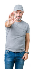 Wall Mural - Handsome middle age hoary senior man wearing sport cap over isolated background doing stop sing with palm of the hand. Warning expression with negative and serious gesture on the face.