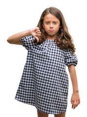 Wall Mural - Brunette hispanic girl wearing black and white dress with angry face, negative sign showing dislike with thumbs down, rejection concept