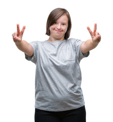 Poster - Young adult woman with down syndrome over isolated background smiling looking to the camera showing fingers doing victory sign. Number two.